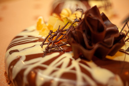 A stunningly decorated chocolate cake featuring intricate designs and delightful toppings of fresh fruitsの写真素材