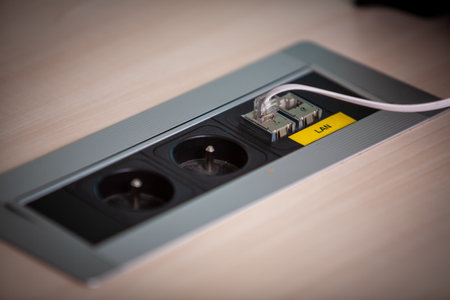 A contemporary power outlet seamlessly integrated into a chic tabletop design for easy and...