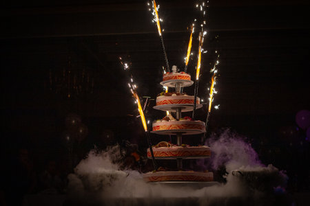 A multilayered cake with vibrant fireworks, creating a magical atmosphere for festive celebrationsの写真素材