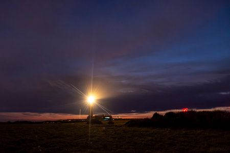 A stunning sunset with a luminous light source casting a glow over the landscape, creating a serene atmosphereの写真素材