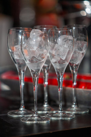 Stylish glasses filled with ice cubes offer a perfect touch for cocktails, parties, and all kinds of celebrationsの写真素材