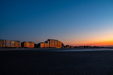 Nieuwpoort, Belgium, October 5th, 2024, A serene and tranquil beachfront scene at sunset showcasing vibrant colors along with beautiful reflectionsの写真素材