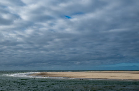 Eierland, De Cocksdorp, Texel, The Netherlands, Oktober 28th, 2024, A wonderfully tranquil coastal scene showcasing a beautiful sandy shore and heavy cloud coverage over the vast oceanの写真素材