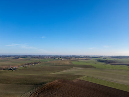 Lier, Antwerp, Belgium, March 5th, 2025, An aerial view captures a stunningly beautiful landscape featuring vibrant green fields beneath a clear blue skyの写真素材