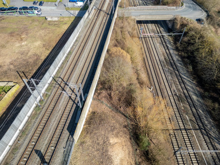 An aerial image showcasing train tracks surrounded by greenery and fieldsの写真素材