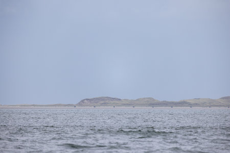 Eierland, De Cocksdorp, Texel, The Netherlands, Oktober 28th, 2024, A serene seascape with calm waters and gentle hills, perfect for nature lovers seeking outdoor beautyの写真素材