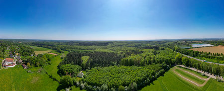 Hallerbos, Halle, Vlaams Brabant, Belgium, 27th of April, 2025, An absolutely breathtaking aerial panorama that showcases vibrant green forests and vast fields under a clear blue skyの写真素材