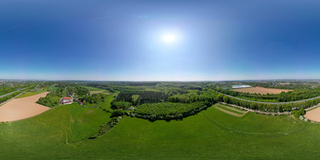 Hallerbos, Halle, Vlaams Brabant, Belgium, 27th of April, 2025, A stunning aerial view showcases the vibrant agricultural fields bathed in sunlight under a clear blue skyの写真素材