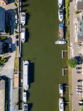 Klein-Willebroek, Willebroek, Antwerp, Belgium, 13th of May, 2025, Here is a breathtaking aerial view showcasing boats peacefully docked in a charming canal embraced by lush greeneryの写真素材