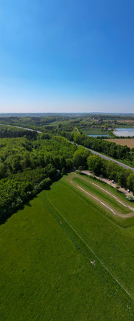 Hallerbos, Halle, Vlaams Brabant, Belgium, 27th of April, 2025, This stunning aerial view brilliantly showcases the vibrant greenery and peaceful water bodies beneath a clear blue sky,の写真素材