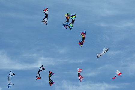 Kites flying in unison trying to catch each other.の写真素材
