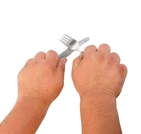 Two thick hands with knife and plug. の写真素材