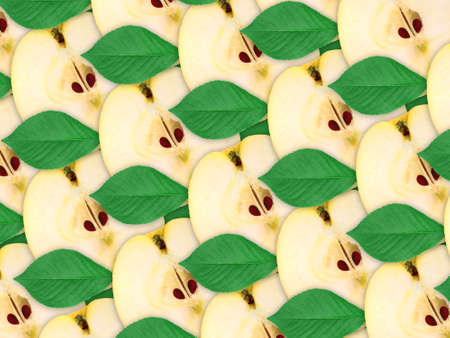 Abstract background of fresh yellow apples slices and green leaf for your design. Close-up. Studio photography. Attention - it is not a seamless pattern.の写真素材