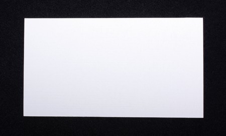 White business card isolated on black velvet background. Empty space for your design.の写真素材