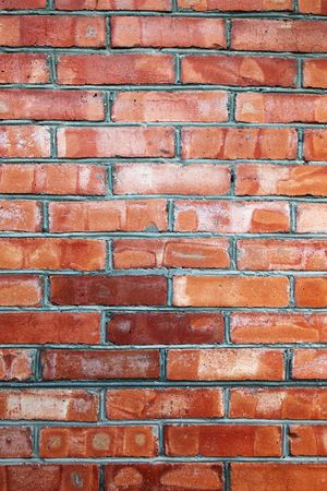 Wall made of bricks. Vertical textured background or backdrop.