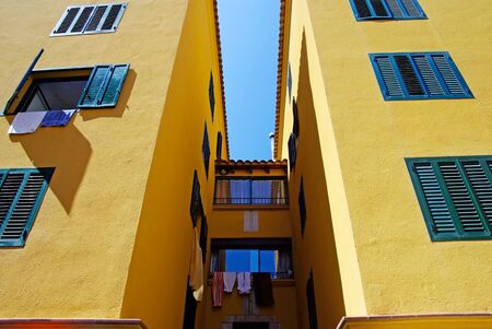 Yellow architecture of small Lloret de Mar city. Costa Brava, Spain.の写真素材
