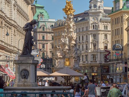 VIENNA, AUSTRIA - JULY 16: People is walking in Graben street Grabenstrasse, main street in old town of Vienna. The column, called The Pestsule Plague column was built in 1693 after epidemics.のeditorial素材