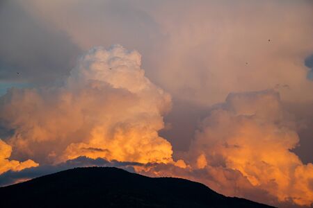 Dramatic sky clouds sunset landscape backgroundの写真素材
