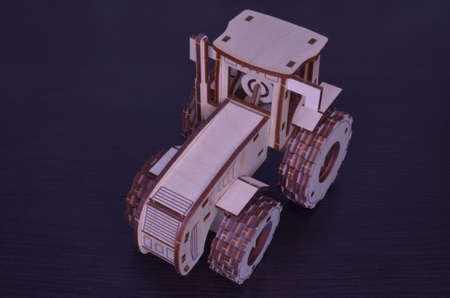 toy wooden tractor on dark backgroundの写真素材