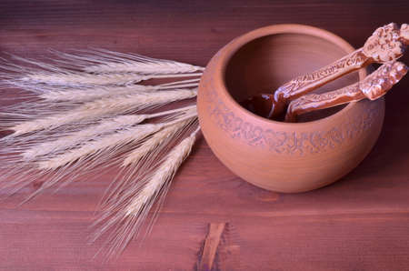 the photo shows a clay pot of ears on a dark backgroundの写真素材