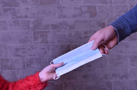 two hands with medical mask against covid