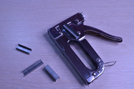 stapler with scattered staples, hand tool on light backgroundの写真素材