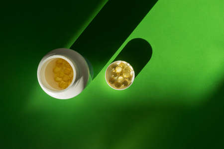 Close up of food supplement oil filled capsules suitable for: fish oil, omega 3, omega 6, omega 9, evening primrose, borage oil, flax seeds oil, vitamin A, vitamin D, vitamin D3, vitamin Eの写真素材