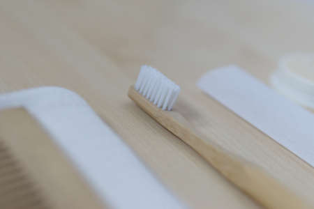 natural oral care in a cozy bathroom in a beautiful morning with a bamboo toothbrush and natural...