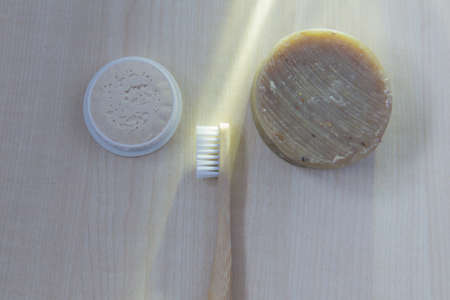 natural oral care in a cozy bathroom in a beautiful morning with a bamboo toothbrush and natural...