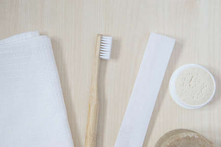 natural oral care in a cozy bathroom in a beautiful morning with a bamboo toothbrush and natural bath accessoriesの写真素材