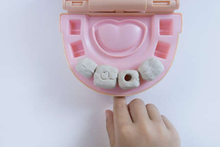 Little boy playing with many-colored plasticine. Boy playing with toys Dental Tools. Facial expression. Children creativity.の写真素材