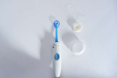 oral irrigator versus floss top view on white backgroundの写真素材