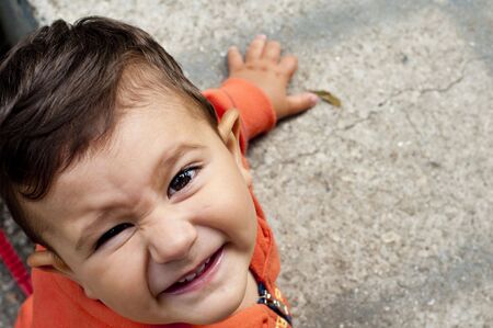 Laughing baby boy enjoying a summer dayの写真素材