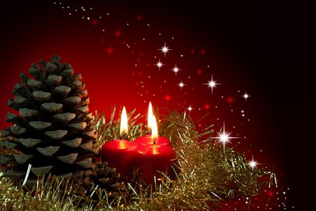 Christmas decoration.Three red burning candles and pineconeの写真素材