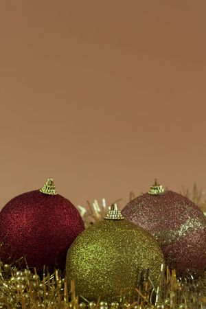 Red,yellow and gold Christmas baubles on orange  background の写真素材