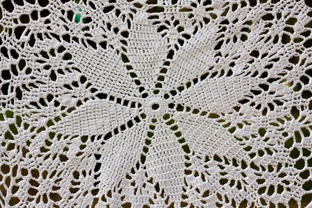Beautiful  white crochet tablecloth for background. 