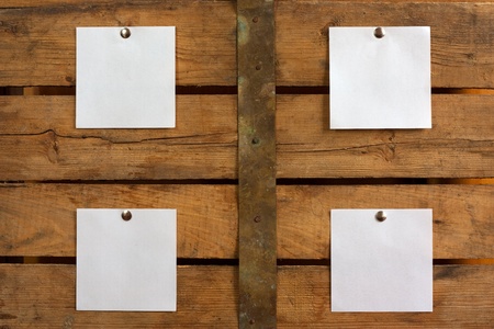 Four pieces of blank paper tacked to wooden background.Ready for your text の写真素材