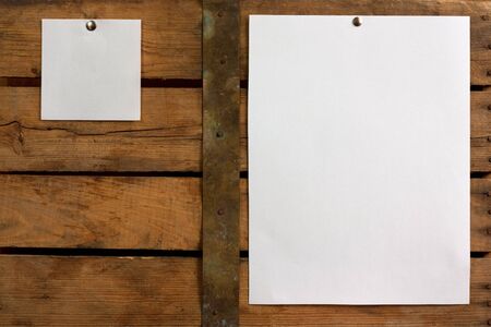 Two pieces of blank paper tacked to wooden background.Ready for your text の写真素材