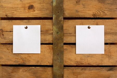 Two pieces of blank paper tacked to wooden background.Ready for your text の写真素材
