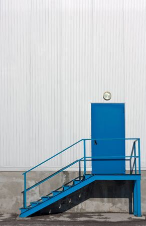 Blue,metal warehouse entry door with stairsの写真素材