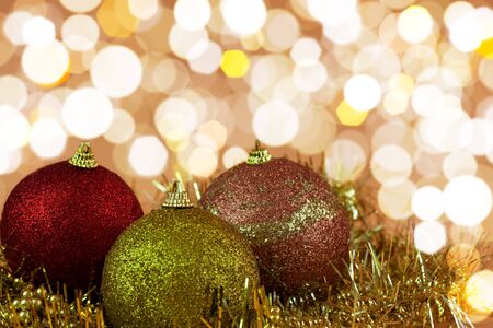 Red,yellow and gold Christmas baubles on background of defocused golden lights.Shallow DOF の写真素材