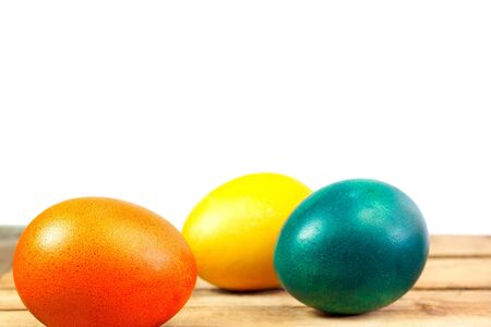Easter eggs on wooden floor over white backgroundの写真素材