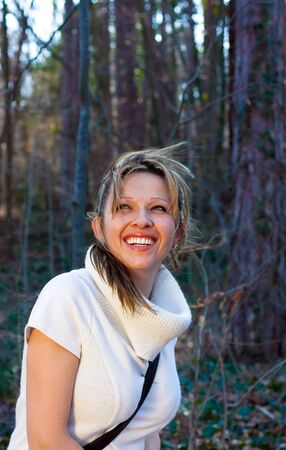 Nice portrait of beautiful woman enjoying the spring sun in the parkの写真素材