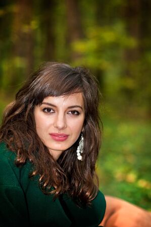Young attractive woman in autumn woods or parkの写真素材