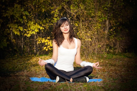 Attractive young woman doing yoga meditation in the park.Gradient effectの写真素材