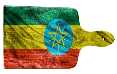 Textured Ethiopia flag painted on old heavily used chopping or cutting board on white backgroundの写真素材