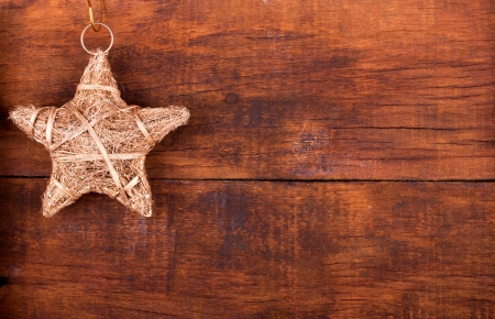 Cristmas decoration.Golden Christmas star on wooden backgroundの写真素材