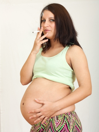 Pregnant woman smoking cigarette.Unhealthy smoker conceptの写真素材