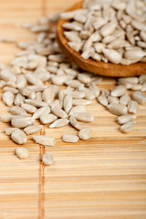 Raw  Shelled Sunflower Seeds on bamboo backgroundの写真素材