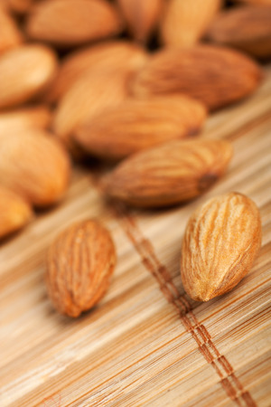Healthy food organic nutrition.Pile of raw almonds on bamboo backgroundの写真素材